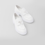patent leather loafers – the triangle logo, first introduced on trunks designed by Mario, decorates the front – LUX VERSE Luxury Designer Fashion Outlet