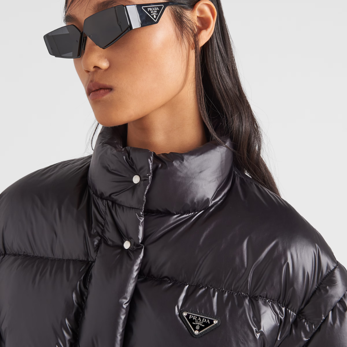 Re-Nylon cropped convertible down jacket – padded with goose down, the garment is decorated with the iconic enameled metal – LUX VERSE Luxury Designer Fashion Outlet