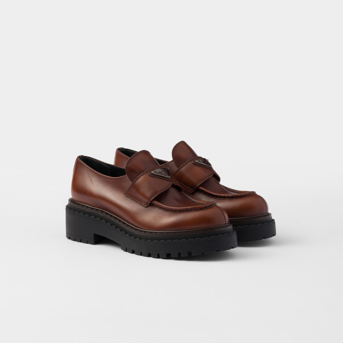 Double Chocolate leather loafers – upper with leather band Enameled metal triangle logo Monoblock rubber sole with 55 – LUX VERSE Luxury Designer Fashion Outlet
