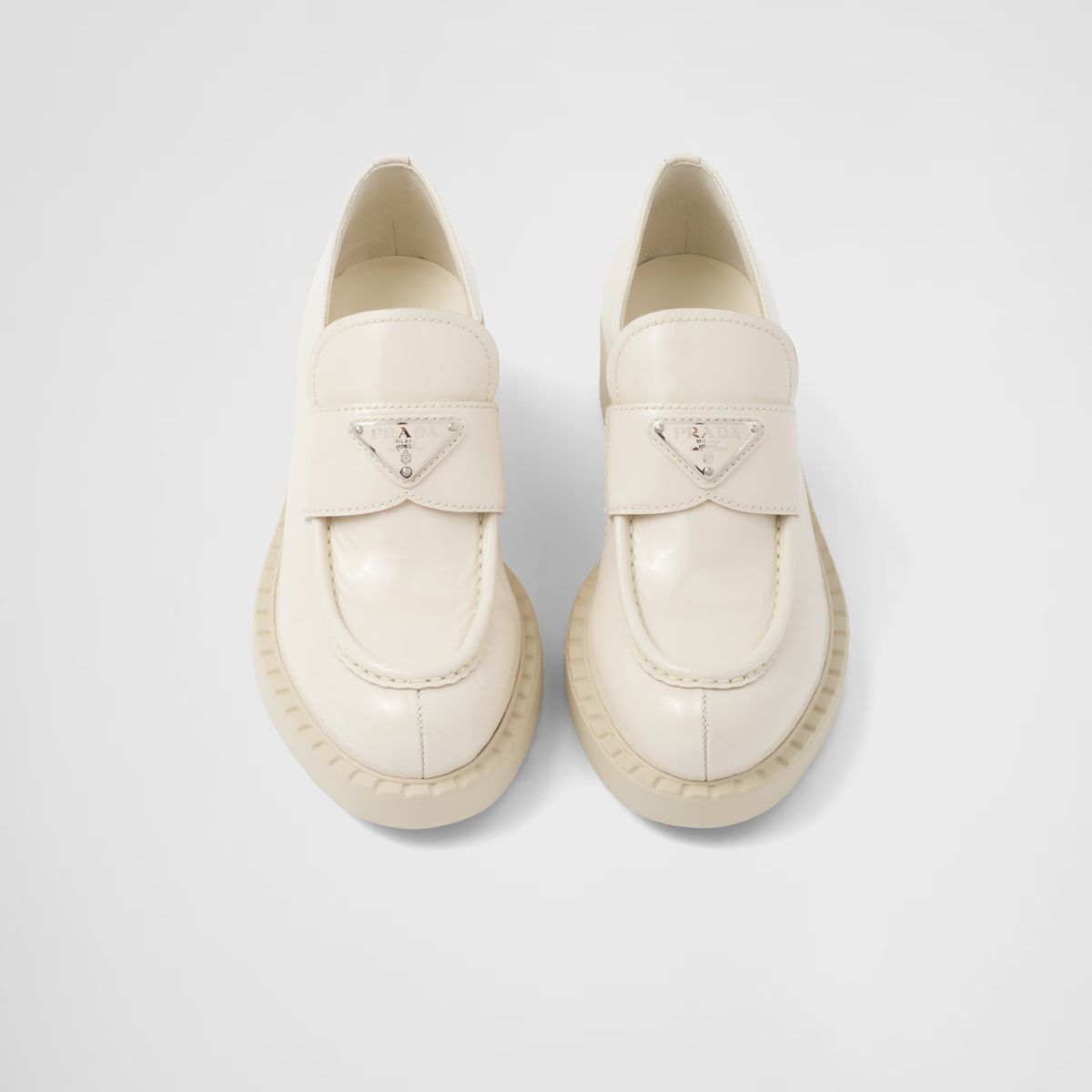 patent leather loafers – the triangle logo, first introduced on trunks designed by Mario, decorates the front – LUX VERSE Luxury Designer Fashion Outlet