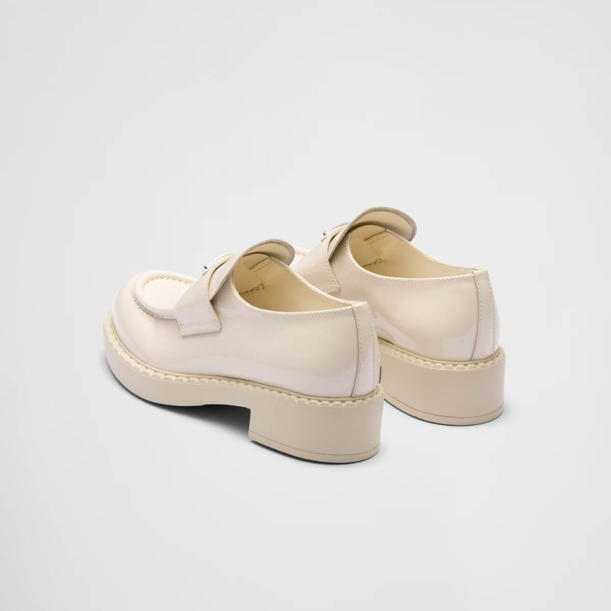patent leather loafers – leather band on the upper Apron with stitched, raised edge Enameled metal triangle – LUX VERSE Luxury Designer Fashion Outlet