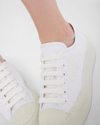 Laced fabric sneakers – the casual and versatile style is embellished with the embossed rubber triangle logo – LUX VERSE Luxury Designer Fashion Outlet