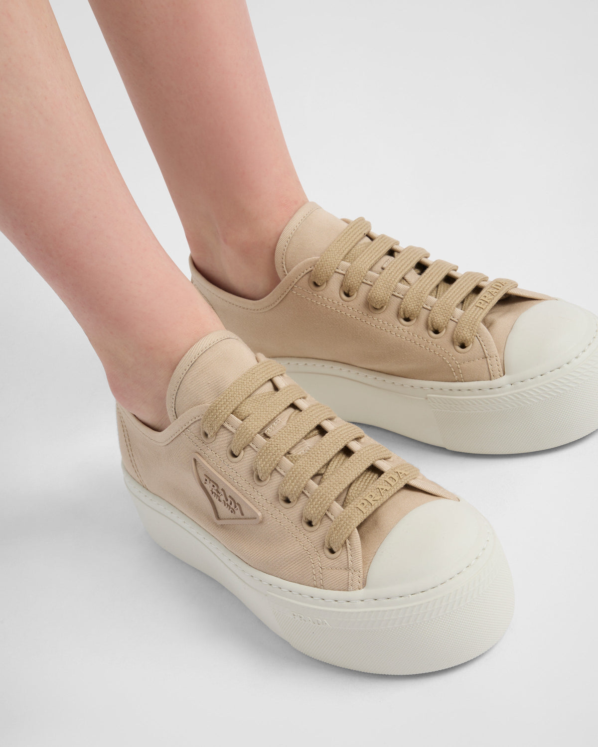Laced sneakers – the casual and versatile style is embellished with the embossed rubber triangle logo – LUX VERSE Luxury Designer Fashion Outlet