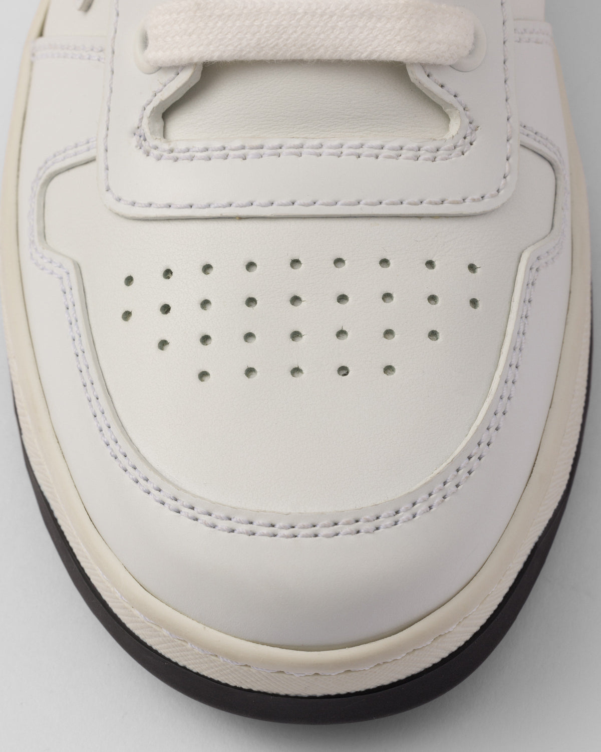 Downtown leather motif sneakers – these sporty leather sneakers are embellished with different interpretations of – LUX VERSE Luxury Designer Fashion Outlet