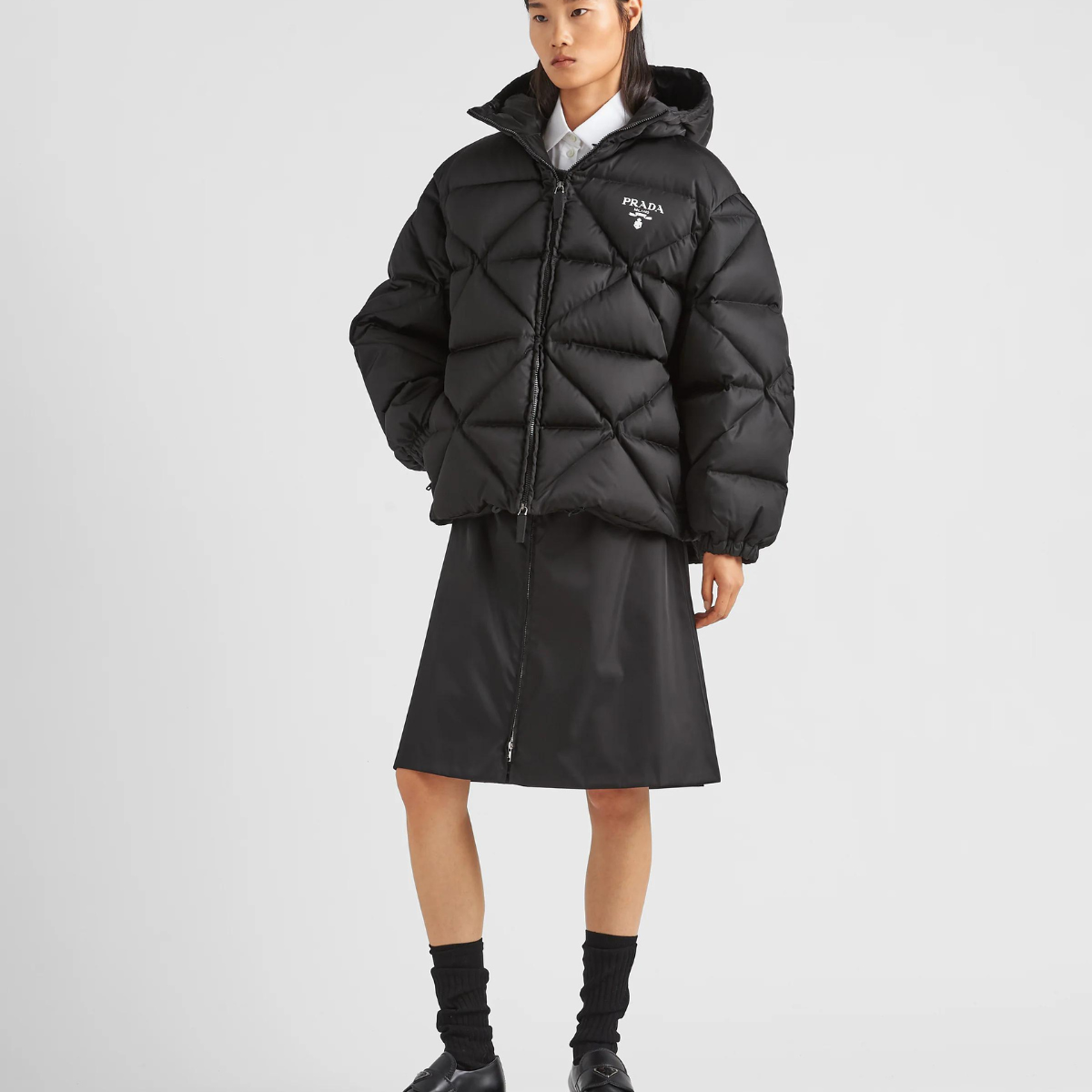 Oversized Re-Nylon Gabardine down jacket – the lettering logo is framed by the iconic triangle that is interpreted – LUX VERSE Luxury Designer Fashion Outlet