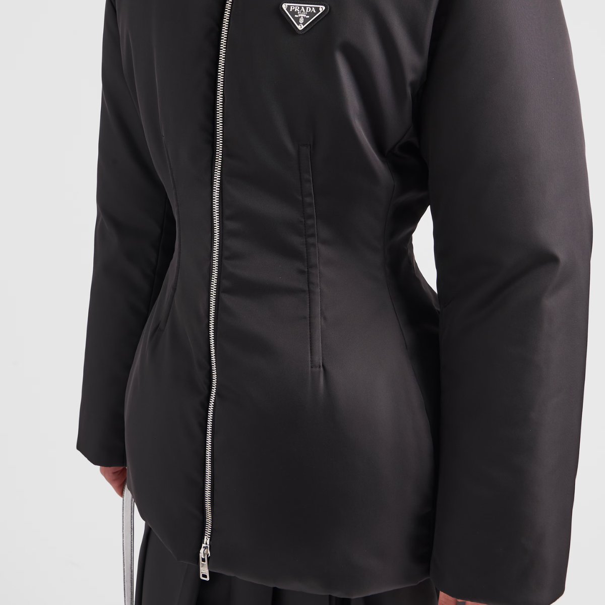 Re-Nylon down iconic jacket – padded with goose down, the garment is decorated with the iconic enameled metal – LUX VERSE Luxury Designer Fashion Outlet