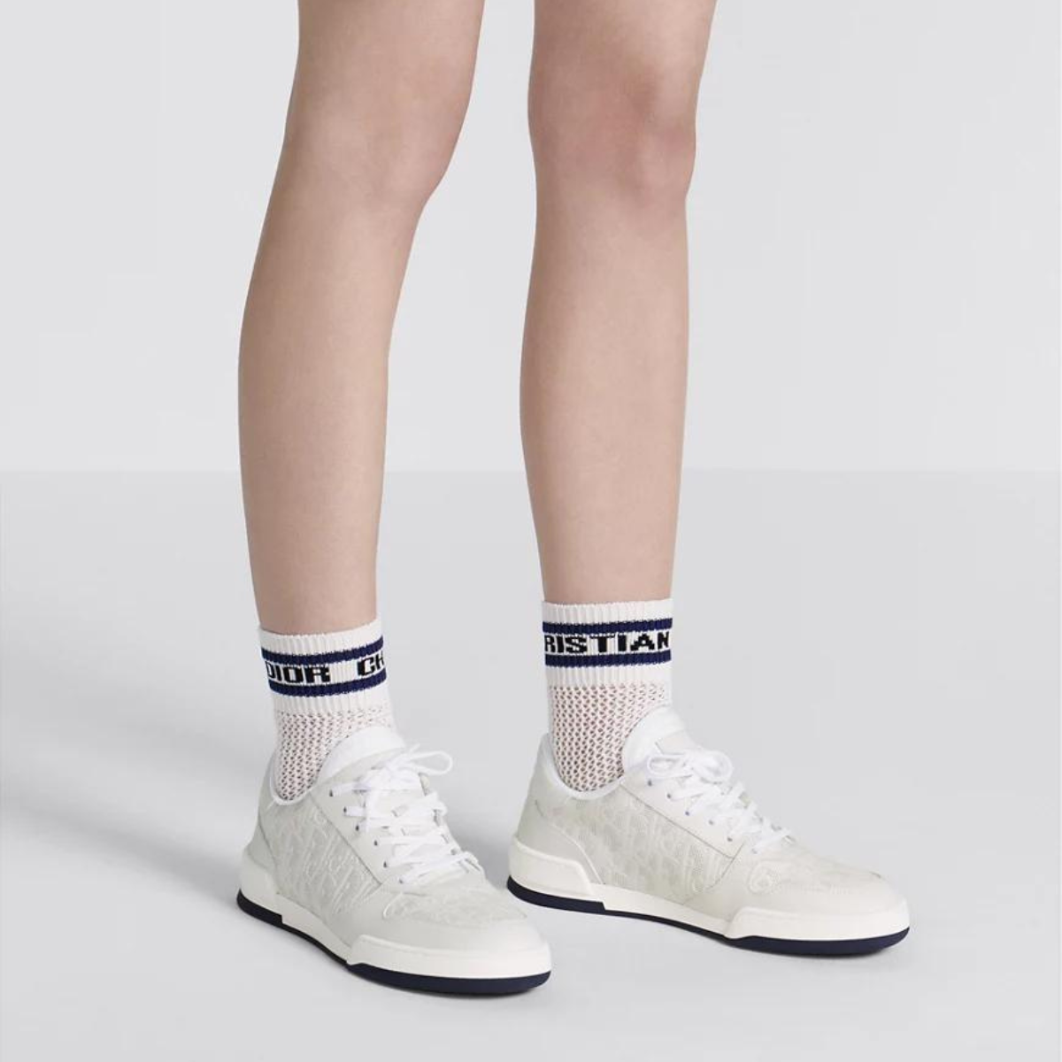 One Sneaker – crafted in white calfskin, it is distinguished with perforated inserts that reveal – LUX VERSE Luxury Designer Fashion Outlet
