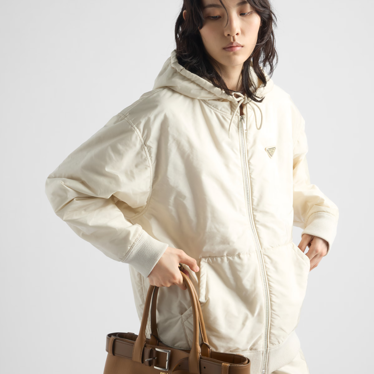Lightweight hooded Re-Nylon blouson jacket – lined Hood Long sleeves Zipper closure Pouch pockets Enameled metal triangle logo – LUX VERSE Luxury Designer Fashion Outlet