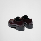 Chocolate brushed leather loafers – upper with leather strap Enameled metal triangle logo 50 mm rubber monobloc sole – LUX VERSE Luxury Designer Fashion Outlet