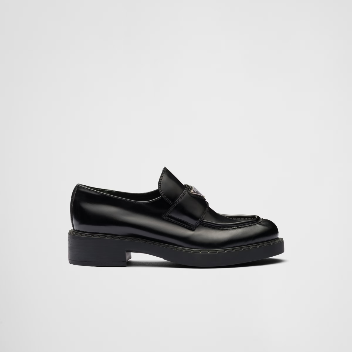 Chocolate brushed leather loafers – upper with leather strap Enameled metal triangle logo 50 mm rubber monobloc sole – LUX VERSE Luxury Designer Fashion Outlet