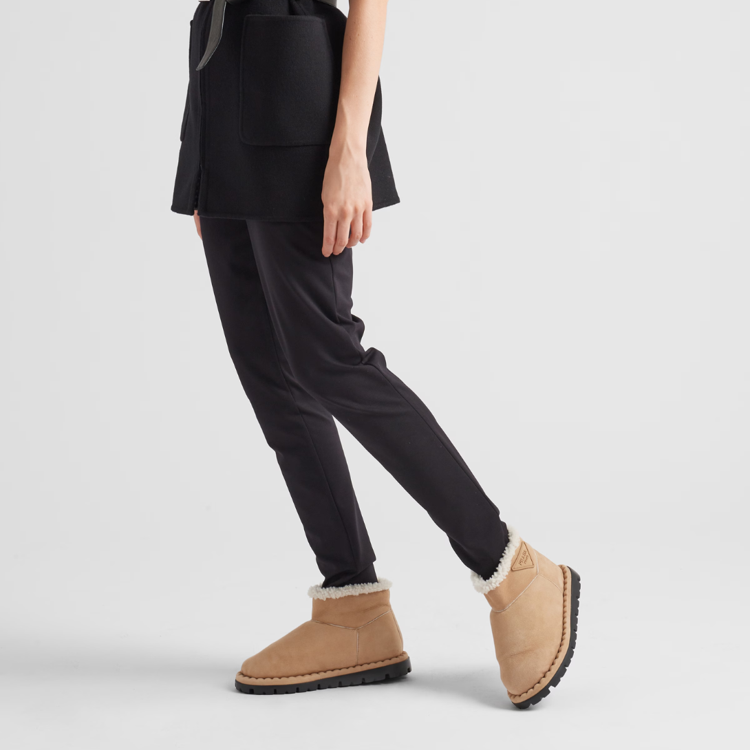 Shearling booties – the triangle logo, reimagined in always new ways, is presented here in embossed – LUX VERSE Luxury Designer Fashion Outlet