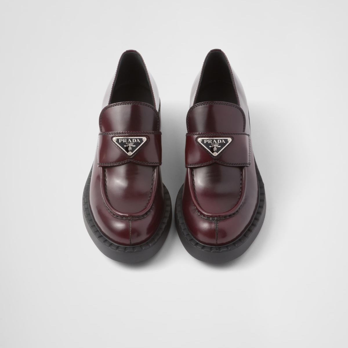 Chocolate brushed leather loafers – upper with leather strap Enameled metal triangle logo 50 mm rubber monobloc sole – LUX VERSE Luxury Designer Fashion Outlet