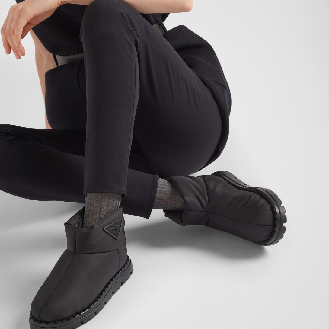 Re-Nylon booties – the triangle logo, reimagined in always new ways, is presented here in embossed – LUX VERSE Luxury Designer Fashion Outlet