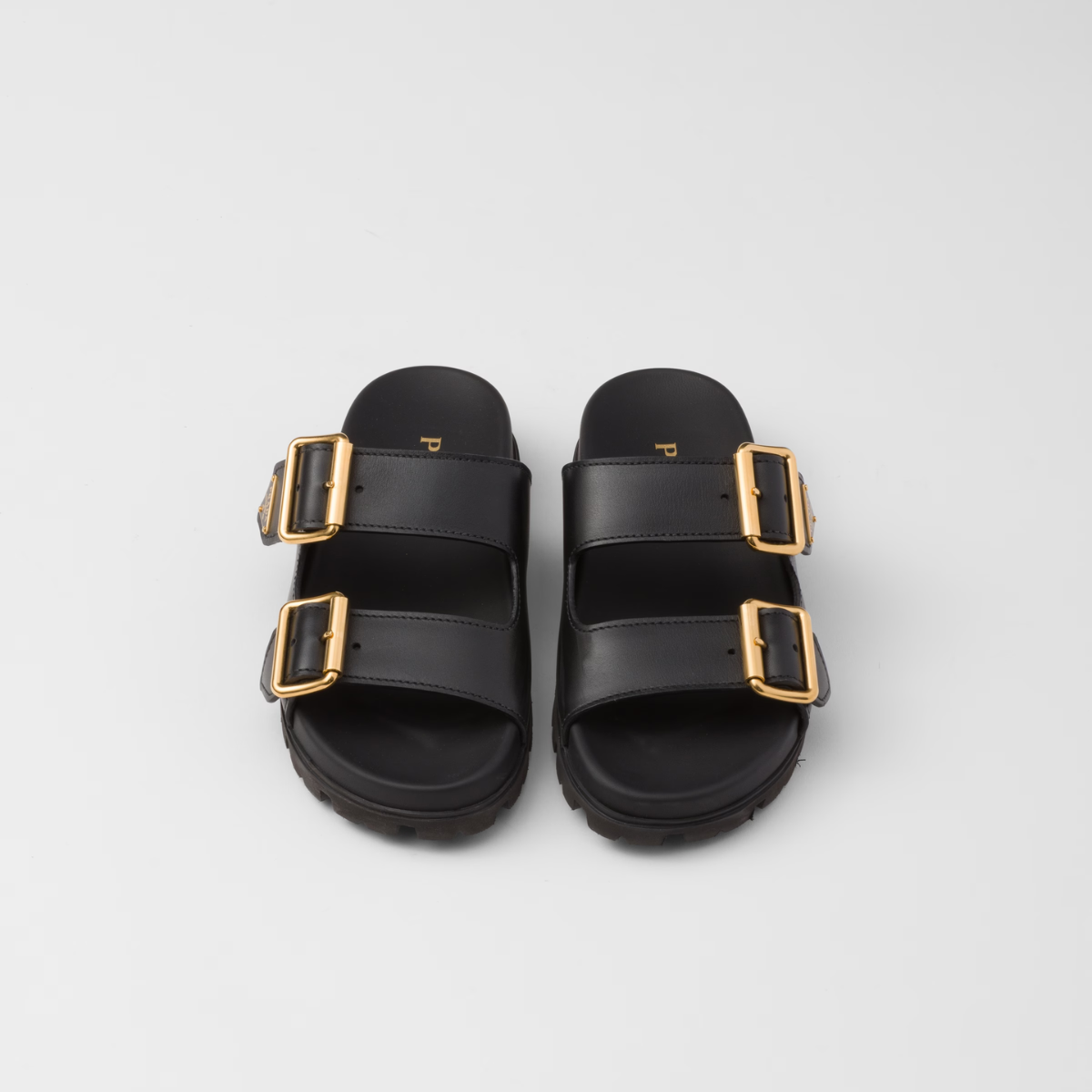 Leather strap slides – the enameled metal triangle logo embellishes the style with its sleek and iconic – LUX VERSE Luxury Designer Fashion Outlet
