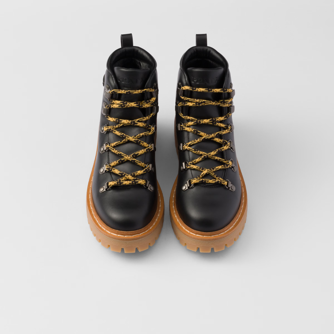 Leather laced booties – upper with metal eyelets and hooks Leather lining Enameled metal triangle logo – LUX VERSE Luxury Designer Fashion Outlet