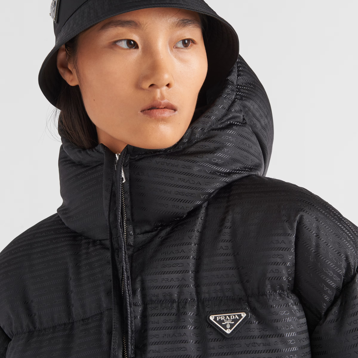 Re-Nylon hooded down jacket – padded with goose down, the garment is decorated with the iconic enameled metal – LUX VERSE Luxury Designer Fashion Outlet