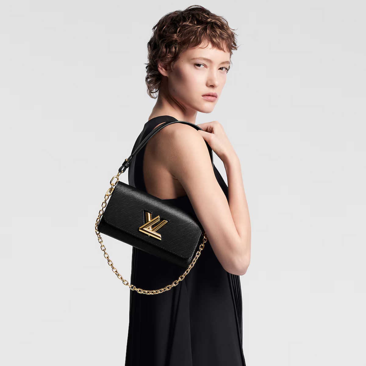 Twist West Handbag – fashioned from Epi leather in an array of modern hues, it is signed with – LUX VERSE Luxury Designer Fashion Outlet