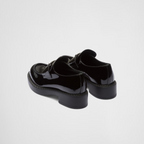 patent leather loafers – the triangle logo, first introduced on trunks designed by Mario, decorates the front – LUX VERSE Luxury Designer Fashion Outlet