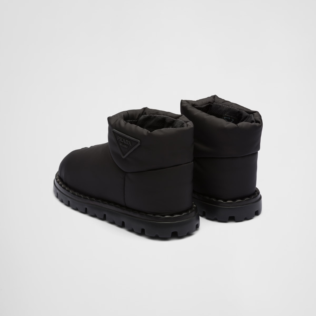 Re-Nylon booties – the triangle logo, reimagined in always new ways, is presented here in embossed – LUX VERSE Luxury Designer Fashion Outlet