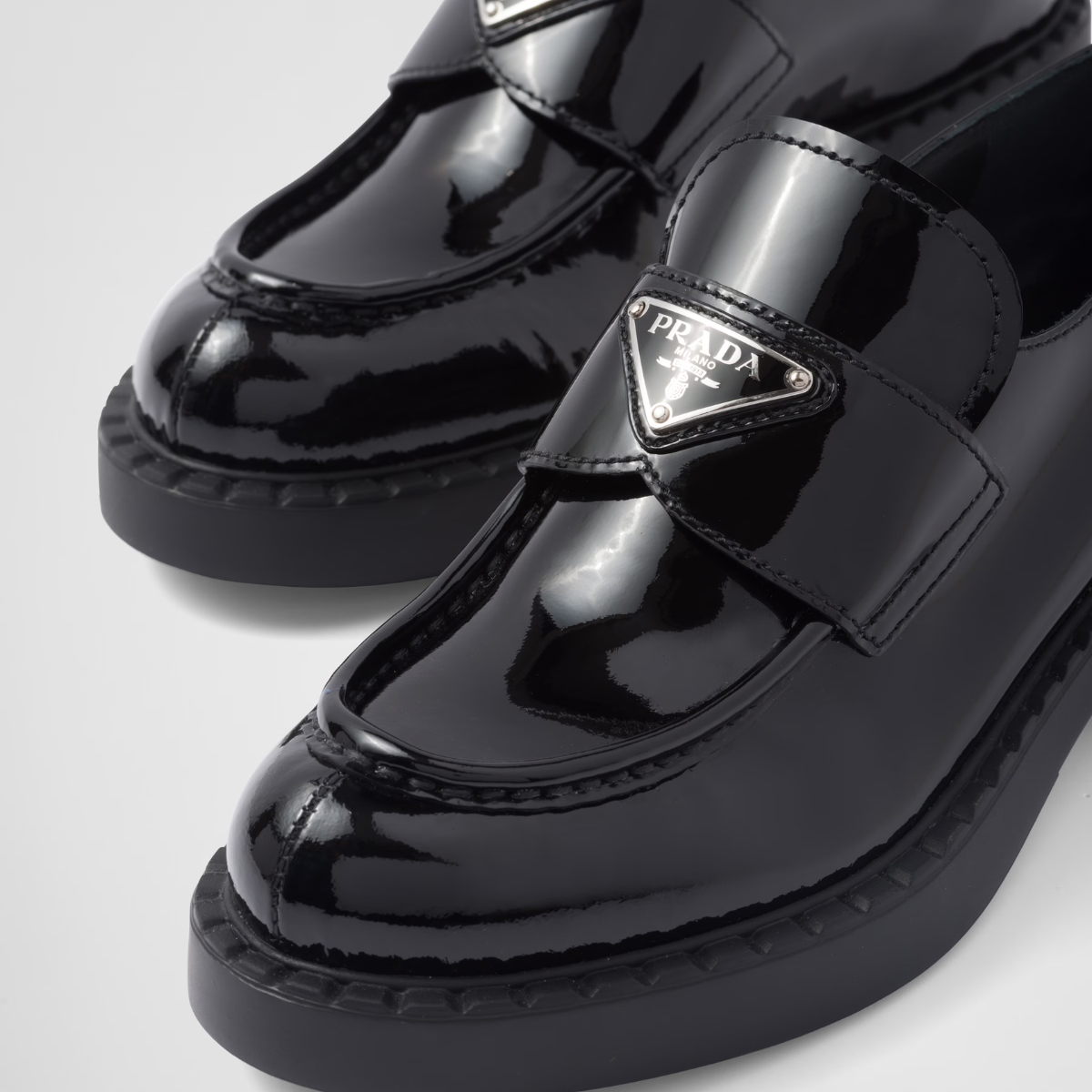 patent leather loafers – leather band on the upper Apron with stitched, raised edge Enameled metal triangle – LUX VERSE Luxury Designer Fashion Outlet