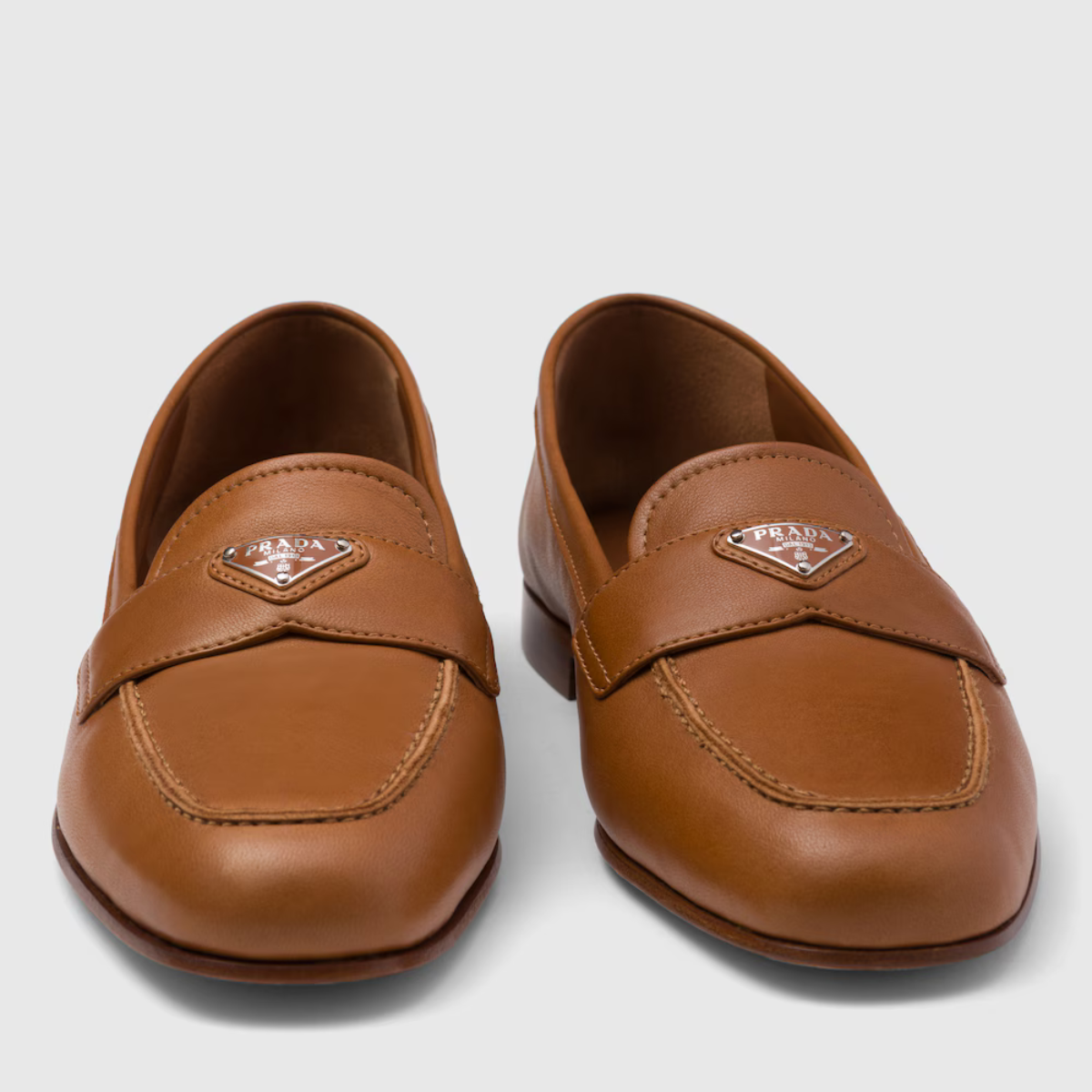 Nappa leather loafers – upper with leather band Enameled metal triangle logo Monoblock leather sole – LUX VERSE Luxury Designer Fashion Outlet