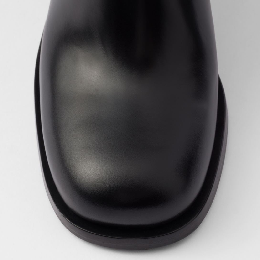 Brushed leather booties Black – the enameled metal triangle logo embellishes the style with its sleek, distinctive – LUX VERSE Luxury Designer Fashion Outlet