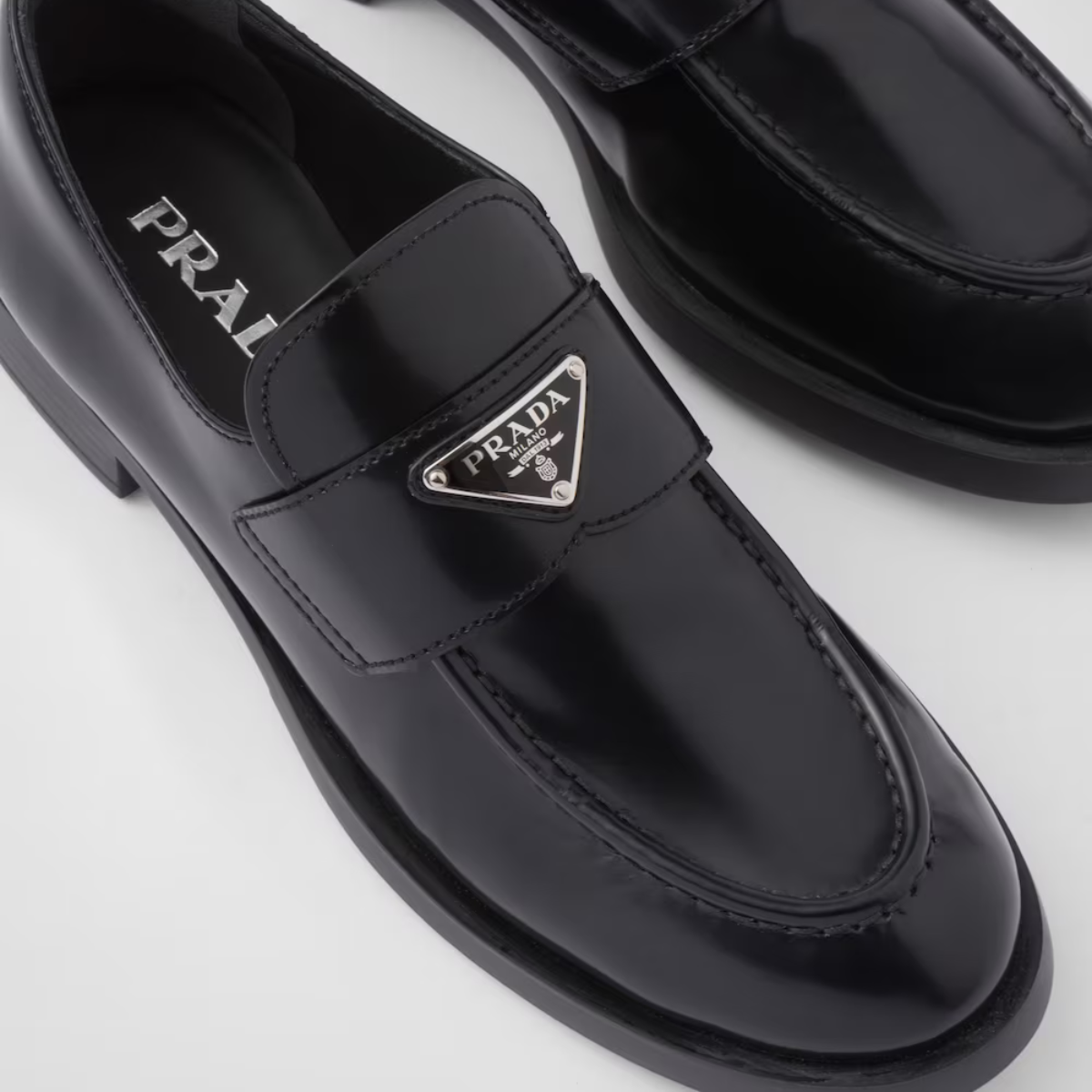 Brushed leather loafers Black – upper with leather band Enameled metal triangle logo Monoblock rubber sole – LUX VERSE Luxury Designer Fashion Outlet