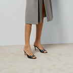 Mid-heel slide sandal – here, this pair of black leather slide sandals is defined by the Horsebit hardware – LUX VERSE Luxury Designer Fashion Outlet