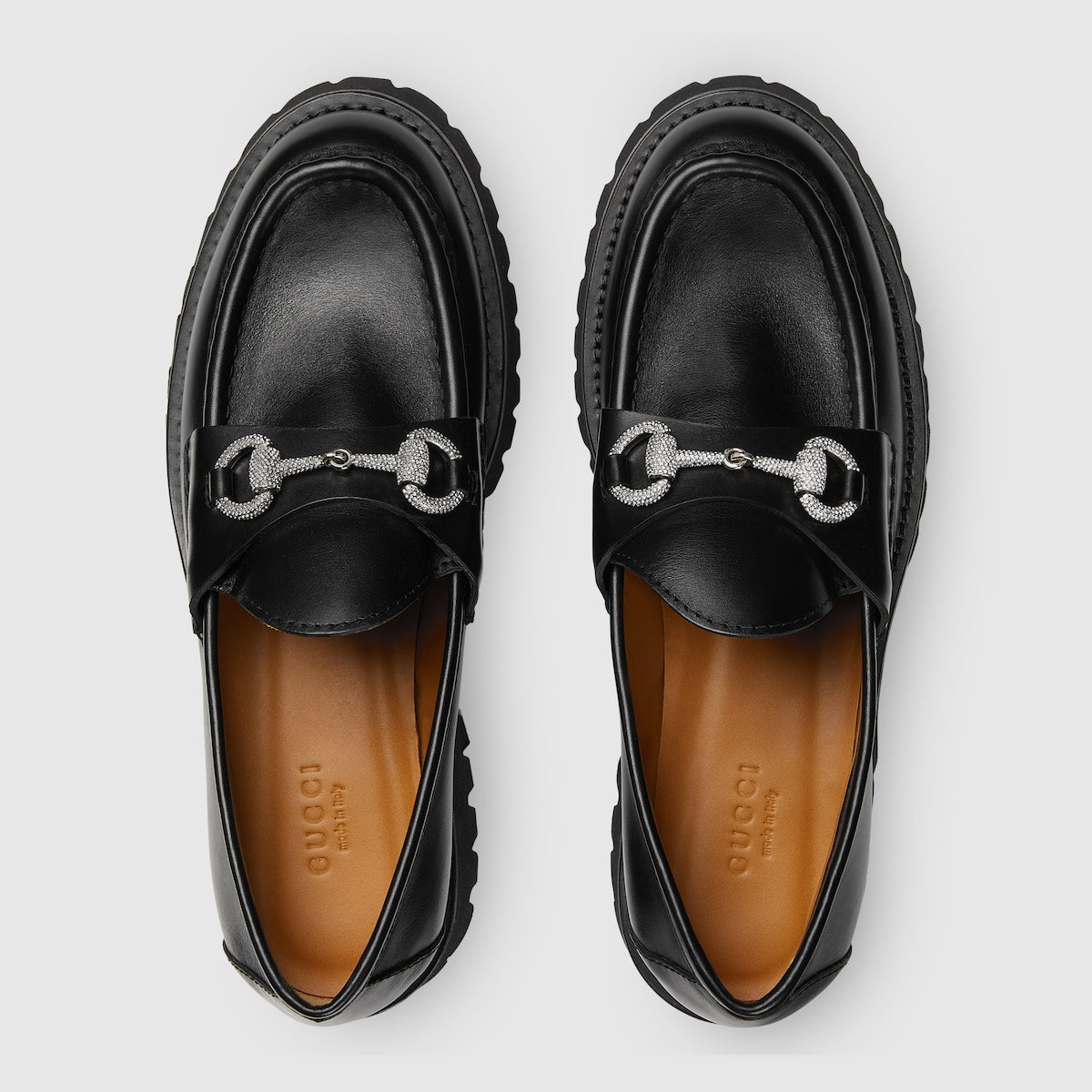 Women's lug sole loafer – a range of shimmering crystals enrich the emblem atop a black leather base – LUX VERSE Luxury Designer Fashion Outlet