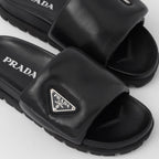 Soft padded nappa leather slides – upper with enameled metal triangle logo 20 mm rubber sole Lug tread Material Leather – LUX VERSE Luxury Designer Fashion Outlet