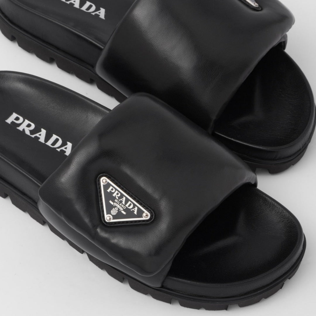 Soft padded nappa leather slides – upper with enameled metal triangle logo 20 mm rubber sole Lug tread Material Leather – LUX VERSE Luxury Designer Fashion Outlet