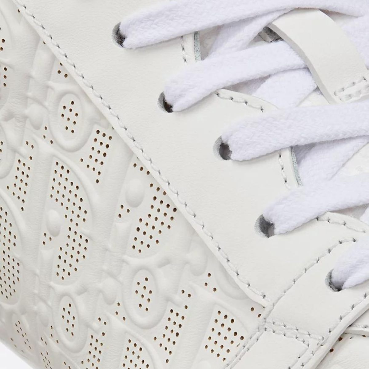 One Sneaker – crafted in white calfskin, it is distinguished with perforated inserts that reveal – LUX VERSE Luxury Designer Fashion Outlet