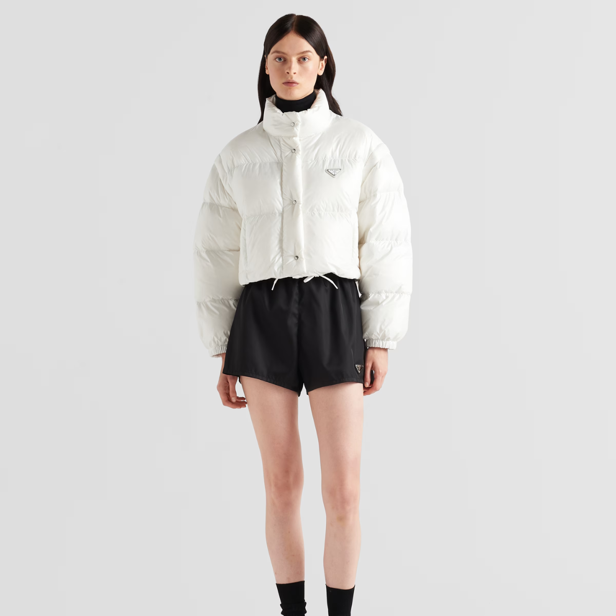 Re-Nylon cropped convertible down jacket – padded with goose down, the garment is decorated with the iconic enameled metal – LUX VERSE Luxury Designer Fashion Outlet