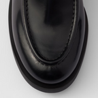 Brushed leather loafers Black – upper with leather band Enameled metal triangle logo Monoblock rubber sole – LUX VERSE Luxury Designer Fashion Outlet