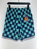 Türkisfarbene karierte Seidenshorts – Herren