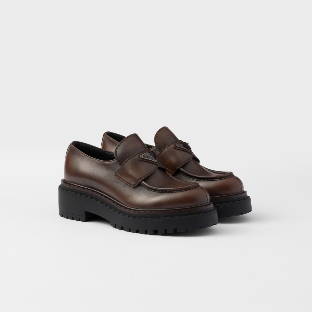 Double Chocolate leather loafers – upper with leather band Enameled metal triangle logo Monoblock rubber sole with 55 – LUX VERSE Luxury Designer Fashion Outlet