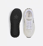 C'est Sneaker – the white calfskin is elevated on either side of the upper by black and white rubber – LUX VERSE Luxury Designer Fashion Outlet