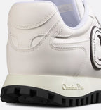 C'est Sneaker – the white calfskin is elevated on either side of the upper by black and white rubber – LUX VERSE Luxury Designer Fashion Outlet