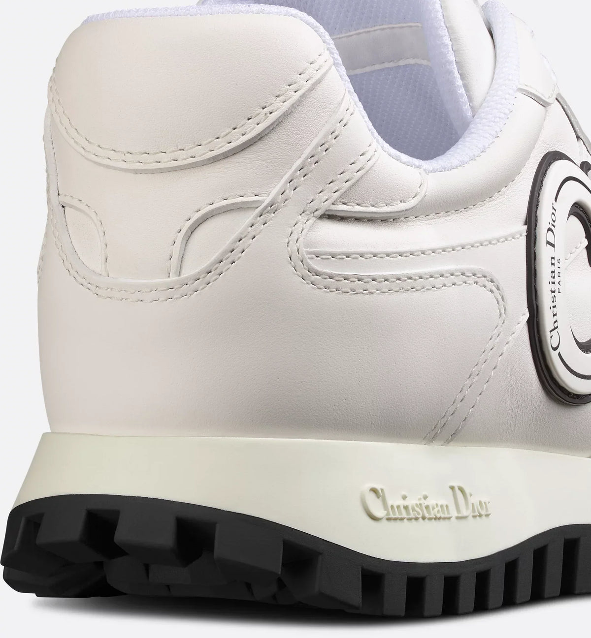 C'est Sneaker – the white calfskin is elevated on either side of the upper by black and white rubber – LUX VERSE Luxury Designer Fashion Outlet
