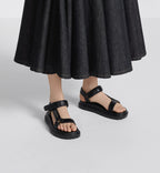D-Wave Trendy Sandal – the style has black lambskin straps enhanced by the gold-tone Christian Paris – LUX VERSE Luxury Designer Fashion Outlet