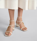 C'est Heeled Sandal – the asymmetric white calfskin upper is complemented by an adjustable buckled strap – LUX VERSE Luxury Designer Fashion Outlet