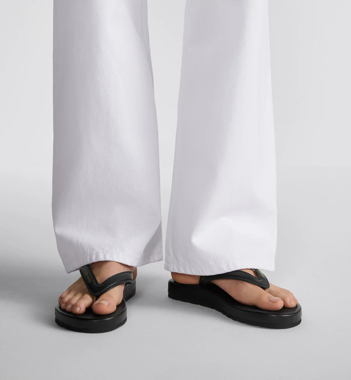 Thong Trendy Sandal – its platform silhouette is crafted in black leather-effect fabric, while the strap – LUX VERSE Luxury Designer Fashion Outlet