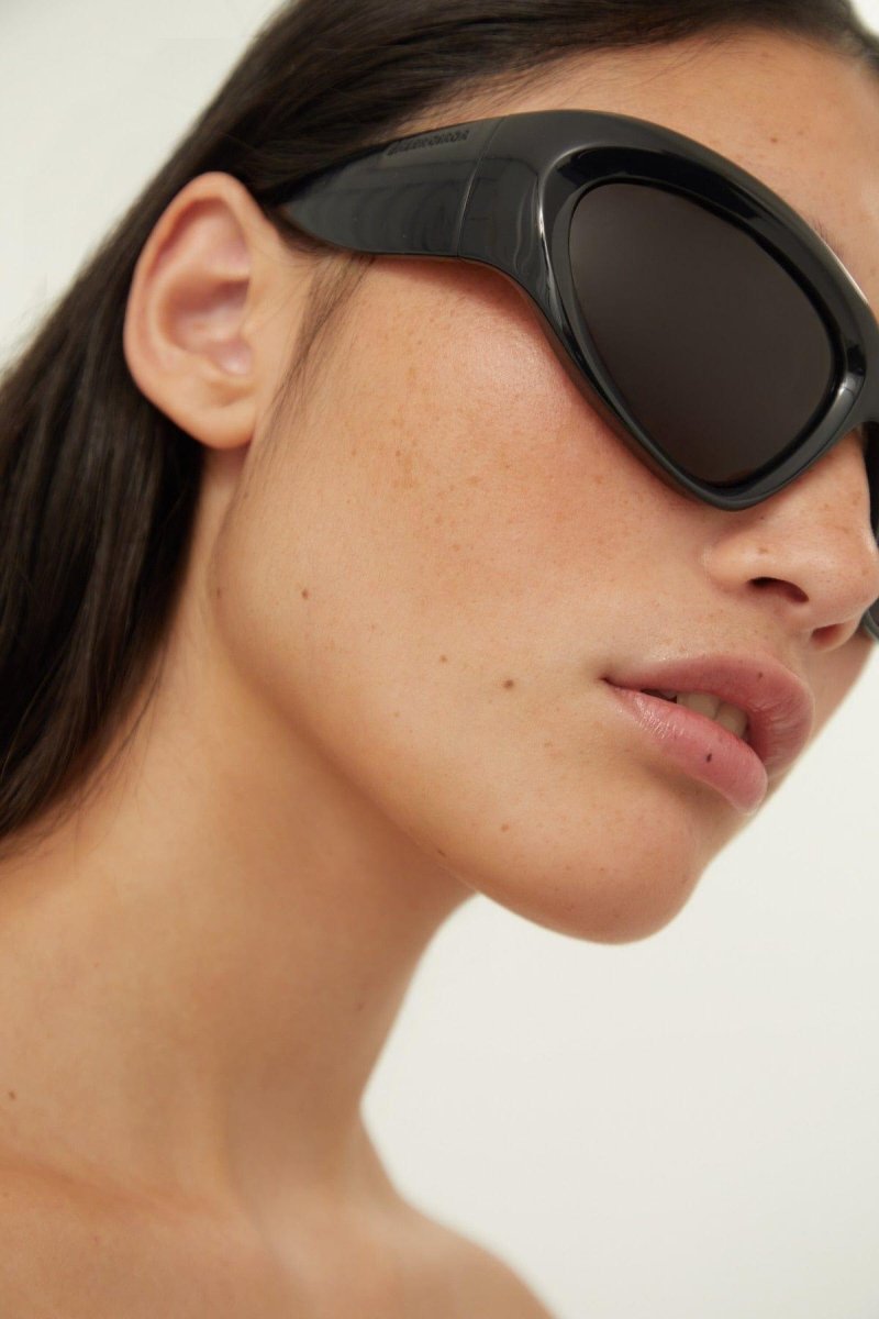 Bold wrap around black sunglasses – oval shape with wrap-around profiles in BIO Injection, sleek and ergonomic design – LUX VERSE Luxury Designer Fashion Outlet