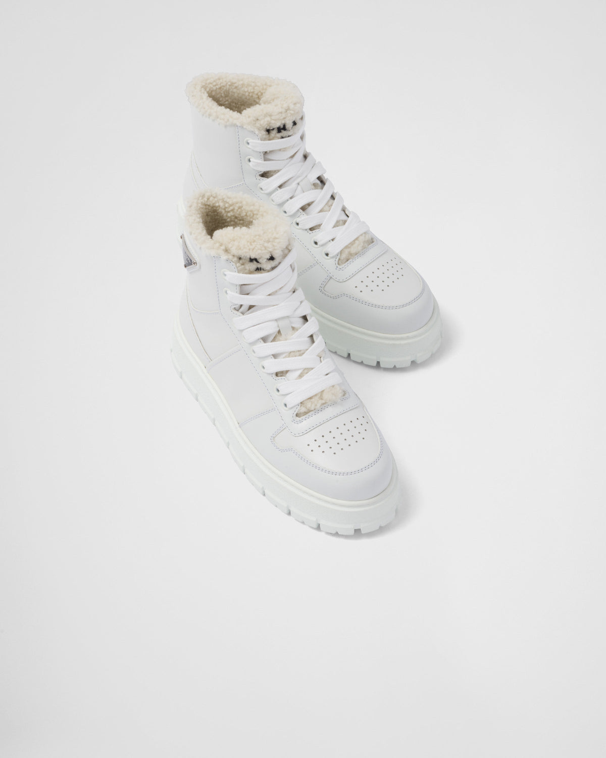 Leather and shearling high-top sneakers – upper with enameled eyelets Shearling lining Enameled metal triangle logo Closure – LUX VERSE Luxury Designer Fashion Outlet