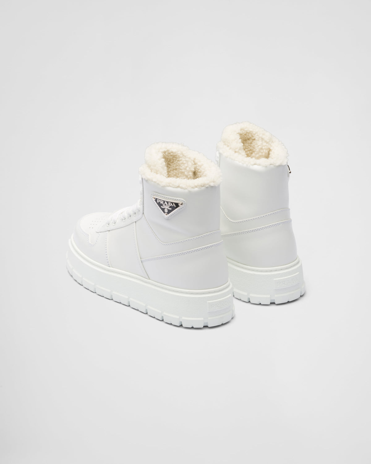 Leather and shearling high-top sneakers – upper with enameled eyelets Shearling lining Enameled metal triangle logo Closure – LUX VERSE Luxury Designer Fashion Outlet