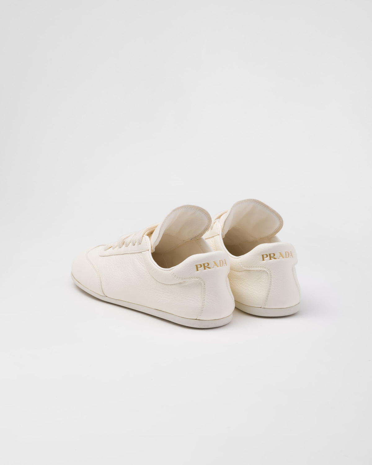 Leather sporty sneakers – the casual and versatile style is embellished with the embossed rubber triangle logo – LUX VERSE Luxury Designer Fashion Outlet