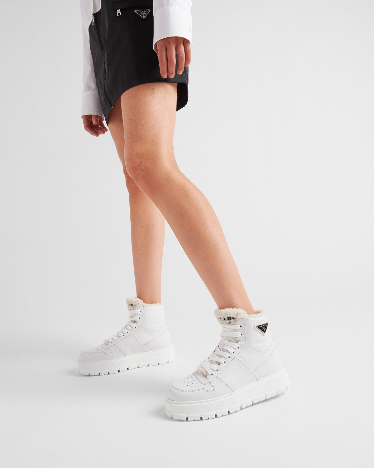 Leather and shearling high-top sneakers – upper with enameled eyelets Shearling lining Enameled metal triangle logo Closure – LUX VERSE Luxury Designer Fashion Outlet