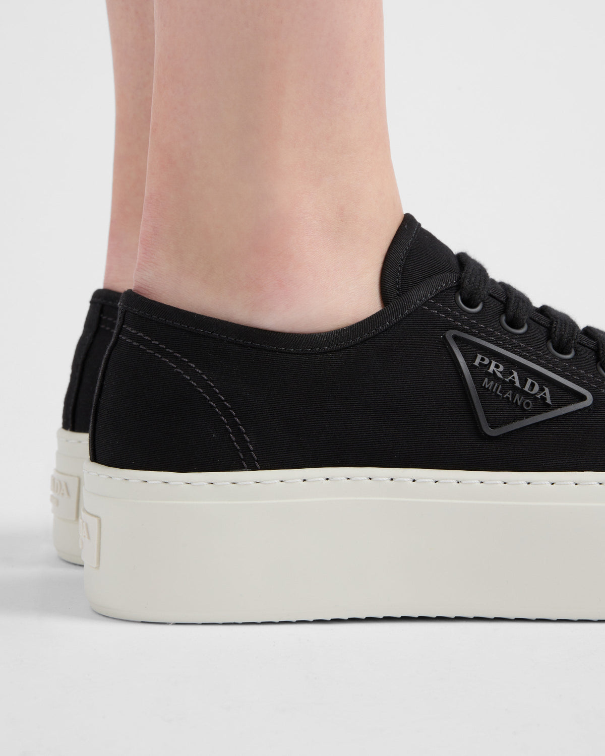 Fabric sneakers – the casual and versatile style is embellished with the embossed rubber triangle logo – LUX VERSE Luxury Designer Fashion Outlet