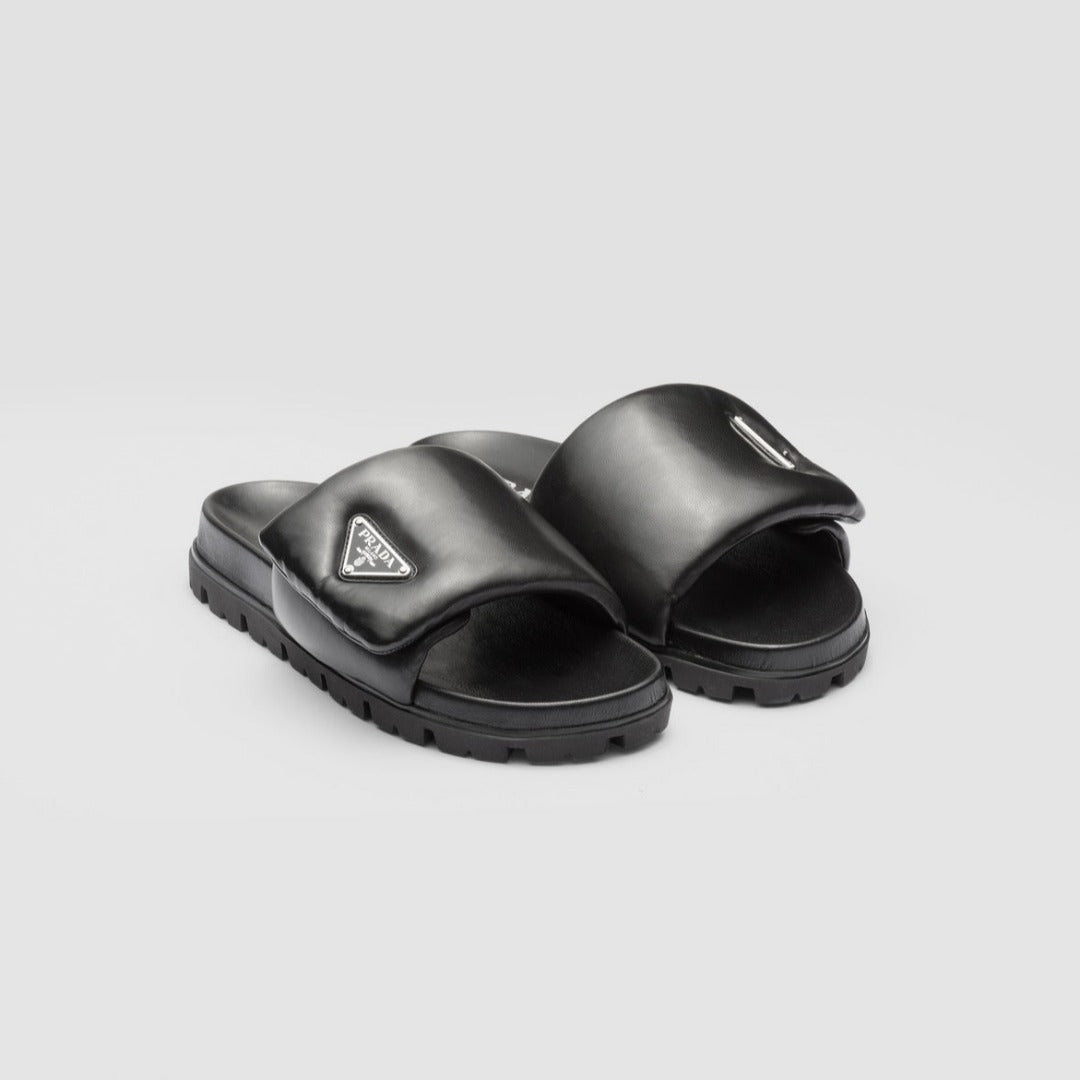 Soft padded nappa leather slides – upper with enameled metal triangle logo 20 mm rubber sole Lug tread Material Leather – LUX VERSE Luxury Designer Fashion Outlet