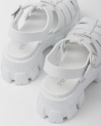 Foam rubber sandals – upper with metal buckle Enameled metal triangle logo Rubber sole: 55 mm Fabric pouch – LUX VERSE Luxury Designer Fashion Outlet